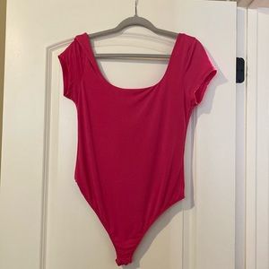 this is a body suit. it is hot pink. it straps on the bottom. it is a size XL